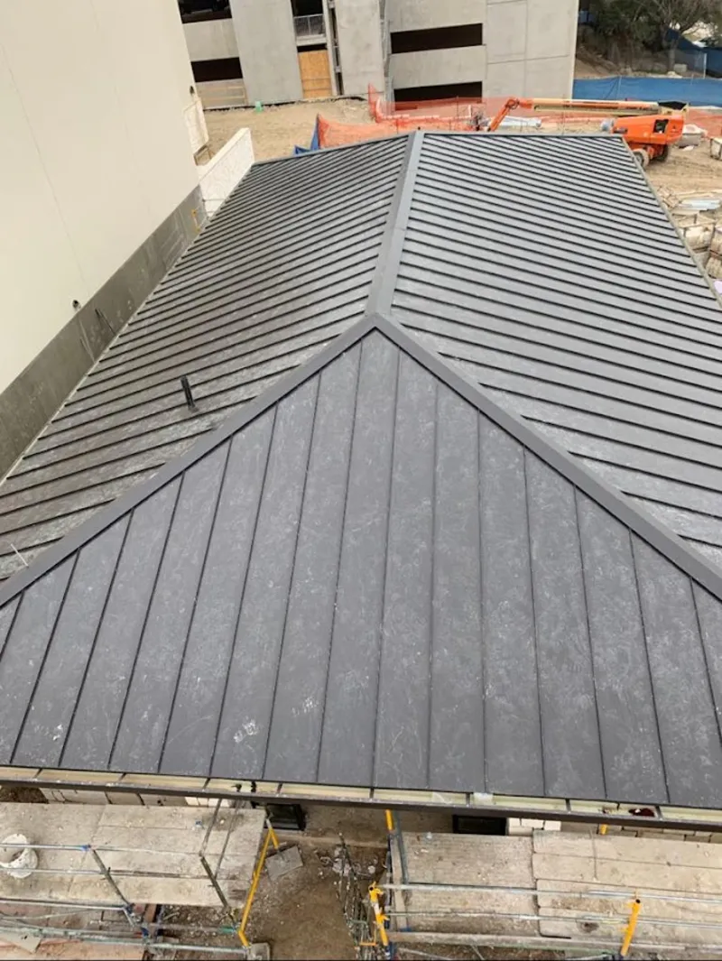 Commercial metal roof construction with crane equipment in Lake Worth Beach