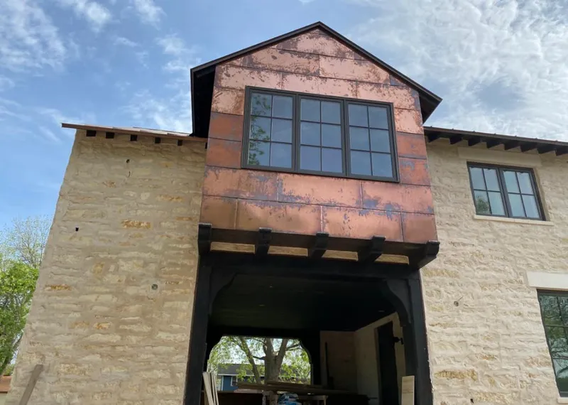 Copper metal panel facade on a stone building for Skylight Installation in Lake Worth Beach
