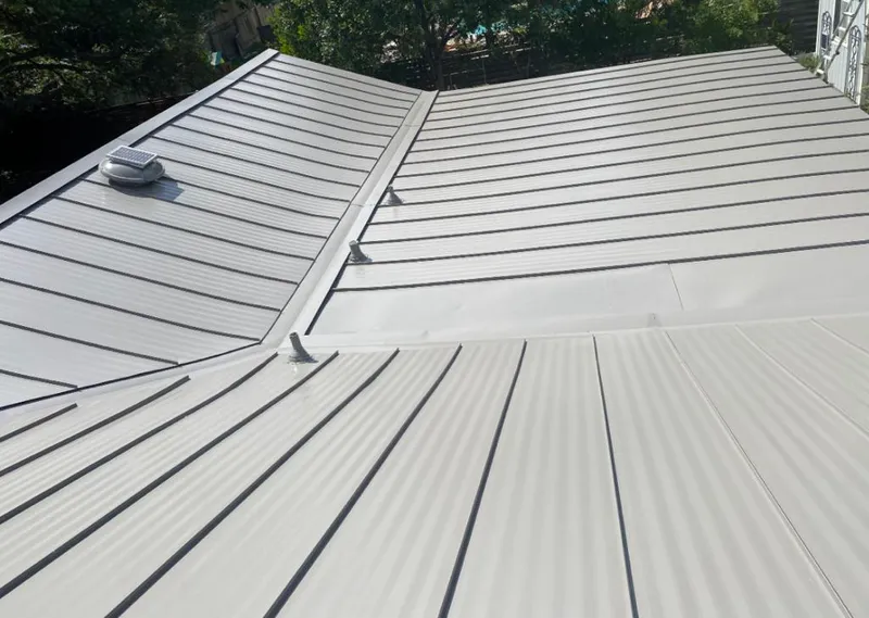 Solar attic fan installed on a metal roof for Roof Ventilation in Lake Worth Beach